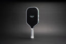 TMP Stealth Pickleball Paddle front view with the Tickle My Pickle wordmark on the black face, against a black gradient background