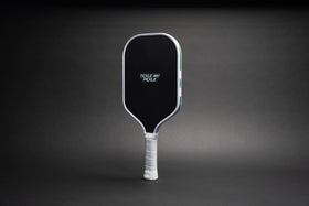 TMP Stealth Pickleball Paddle front view with the Tickle My Pickle wordmark on the black face, against a black gradient background